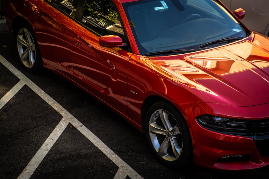 Professional automotive paint job showcasing metallic blue finish on a luxury sedan